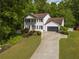 Beautiful two-story home with a manicured lawn and a long driveway that leads to a two-car garage at 731 Sacketts Ct, Lawrenceville, GA 30043