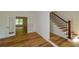 Foyer view featuring new hardwood floors, white trim, and a staircase with iron spindles at 731 Sacketts Ct, Lawrenceville, GA 30043