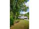Traditional two-story home with black shutters, surrounded by a green lawn and mature trees at 731 Sacketts Ct, Lawrenceville, GA 30043