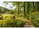 Lush front lawn and garden showcasing natural beauty and curb appeal with mature trees at 731 Sacketts Ct, Lawrenceville, GA 30043