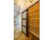 Hallway with natural stone floors and a sliding door to a pantry with wire shelving at 731 Sacketts Ct, Lawrenceville, GA 30043