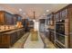 Gourmet kitchen with custom cabinetry, stainless appliances, an island, and tiled floors at 731 Sacketts Ct, Lawrenceville, GA 30043
