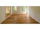 Bright room with new hardwood floors and a door leading to another room at 731 Sacketts Ct, Lawrenceville, GA 30043