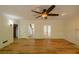 Open living room featuring a ceiling fan, new hardwood floors, and views into other rooms at 731 Sacketts Ct, Lawrenceville, GA 30043