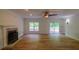 Spacious living room with a fireplace, new hardwood floors, and natural light from windows at 731 Sacketts Ct, Lawrenceville, GA 30043