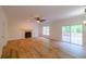 Spacious living room with hardwood floors, fireplace, natural light, and access to the outdoor patio at 731 Sacketts Ct, Lawrenceville, GA 30043