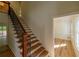 View of wooden staircase with black iron railing and view to the front of the home at 731 Sacketts Ct, Lawrenceville, GA 30043