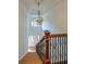 Grand staircase with wood treads, iron balusters, and a view of the front entry at 731 Sacketts Ct, Lawrenceville, GA 30043