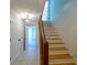 Entryway stairway with wooden banister, tile flooring and access to upper level at 731 Sacketts Ct, Lawrenceville, GA 30043