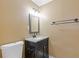 Small bathroom featuring dark vanity with light countertop, mirror, and toilet at 992 Estes Sw Dr, Atlanta, GA 30310