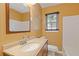 Bathroom featuring a light countertop, wood cabinet and mirror at 992 Estes Sw Dr, Atlanta, GA 30310