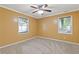 Cozy bedroom with neutral carpet, ceiling fan, and natural light from the window at 992 Estes Sw Dr, Atlanta, GA 30310