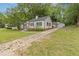 A cozy single-story house featuring a long driveway leading to a detached garage at 992 Estes Sw Dr, Atlanta, GA 30310