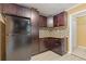 Kitchen with dark cabinets and stainless steel refrigerator with door to pantry or laundry room at 992 Estes Sw Dr, Atlanta, GA 30310