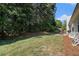 Lush backyard with mature trees and patio area, offering a private outdoor retreat at 1180 Chandler Ridge Dr, Lawrenceville, GA 30045