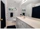 Modern bathroom with white vanity, geometric wallpaper, and a black shower curtain at 1180 Chandler Ridge Dr, Lawrenceville, GA 30045