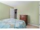 A green-painted bedroom boasts a full bed and wooden dresser, creating a cozy and functional space at 1180 Chandler Ridge Dr, Lawrenceville, GA 30045