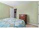 This bedroom features bright green walls, carpet, a bed, and a small dresser near the doorway at 1180 Chandler Ridge Dr, Lawrenceville, GA 30045