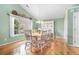 Bright and airy dining room with hardwood floors, large windows, and stylish decor at 1180 Chandler Ridge Dr, Lawrenceville, GA 30045