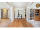 Inviting hallway with gleaming hardwood floors, neutral paint, and view to rooms in this stylish home at 1180 Chandler Ridge Dr, Lawrenceville, GA 30045