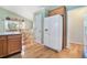 View of kitchen featuring hardwood floors, a white refrigerator, and a dining area with natural light at 1180 Chandler Ridge Dr, Lawrenceville, GA 30045