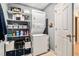 Functional laundry area with stacked washer/dryer and shelving, providing ample storage at 1180 Chandler Ridge Dr, Lawrenceville, GA 30045