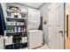 Functional laundry area with stacked washer/dryer, shelving, and a bright interior, maximizing space at 1180 Chandler Ridge Dr, Lawrenceville, GA 30045