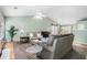 Bright living room with vaulted ceilings, neutral paint, plush carpet, and an open view to the dining area at 1180 Chandler Ridge Dr, Lawrenceville, GA 30045