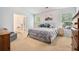 Spacious main bedroom with neutral tones, comfortable bed, and natural light from two windows at 1180 Chandler Ridge Dr, Lawrenceville, GA 30045