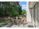 Outdoor patio features a table and chairs, perfect for relaxing and enjoying the green yard at 1180 Chandler Ridge Dr, Lawrenceville, GA 30045
