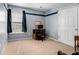 Cozy bedroom features a desk, neutral carpet, and gray walls with a navy accent stripe at 1180 Chandler Ridge Se Dr, Lawrenceville, GA 30045