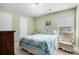 A welcoming bedroom features a comfortable bed, a charming chair, and plenty of natural light at 1180 Chandler Ridge Se Dr, Lawrenceville, GA 30045