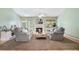 Cozy living room features plush seating, fireplace, hardwood floors, and ample natural light at 1180 Chandler Ridge Se Dr, Lawrenceville, GA 30045