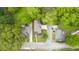 Aerial view of a modern house surrounded by lush green trees and neighboring homes at 1676 Carroll Nw Dr, Atlanta, GA 30318