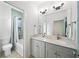Bathroom featuring double vanity, marble countertops, and tiled shower with glass door at 1676 Carroll Nw Dr, Atlanta, GA 30318