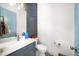 Stylish half bath with marble countertop, blue vanity and decorative tile floor at 1676 Carroll Nw Dr, Atlanta, GA 30318