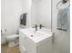 Bathroom with modern sink, mirror, toilet, and wood-look flooring at 1676 Carroll Nw Dr, Atlanta, GA 30318
