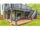 Home deck with patio furniture, stairs, and fenced yard at 1676 Carroll Nw Dr, Atlanta, GA 30318