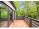 Wood deck with a view of surrounding trees with access from a bedroom at 1676 Carroll Nw Dr, Atlanta, GA 30318