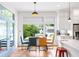 Dining area with a view of the back yard features a wood table and a blue door at 1676 Carroll Nw Dr, Atlanta, GA 30318