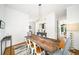 Spacious dining room with a long wooden table and seating for six at 1676 Carroll Nw Dr, Atlanta, GA 30318