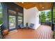 Modern front porch with seating area, wood decking, black trim, and stylish design at 1676 Carroll Nw Dr, Atlanta, GA 30318