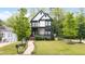 Beautiful modern home with manicured lawn, front porch, and landscaped walkway at 1676 Carroll Nw Dr, Atlanta, GA 30318