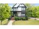 Modern home with a landscaped front yard, covered porch, and stylish curb appeal at 1676 Carroll Nw Dr, Atlanta, GA 30318