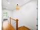 Upstairs hallway with wood floors, white trim, and natural light at 1676 Carroll Nw Dr, Atlanta, GA 30318