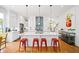 Eat-in kitchen featuring red bar stool seating at the island, stainless appliances, and modern fixtures at 1676 Carroll Nw Dr, Atlanta, GA 30318