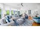 Open-concept living room with large windows seamlessly connects to the modern, well-equipped kitchen at 1676 Carroll Nw Dr, Atlanta, GA 30318