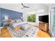 Bright main bedroom with a modern ceiling fan, large windows, and an en-suite bathroom at 1676 Carroll Nw Dr, Atlanta, GA 30318