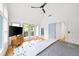 Bright main bedroom with vaulted ceiling, light hardwood floors, and doors to a private deck at 1676 Carroll Nw Dr, Atlanta, GA 30318