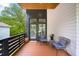 Inviting porch with wood floors and seating offers a welcoming entryway to this lovely home at 1676 Carroll Nw Dr, Atlanta, GA 30318